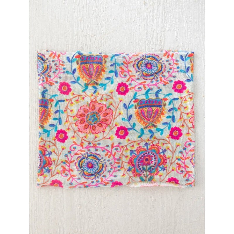 Colorful floral and paisley patterned fabric on a white background